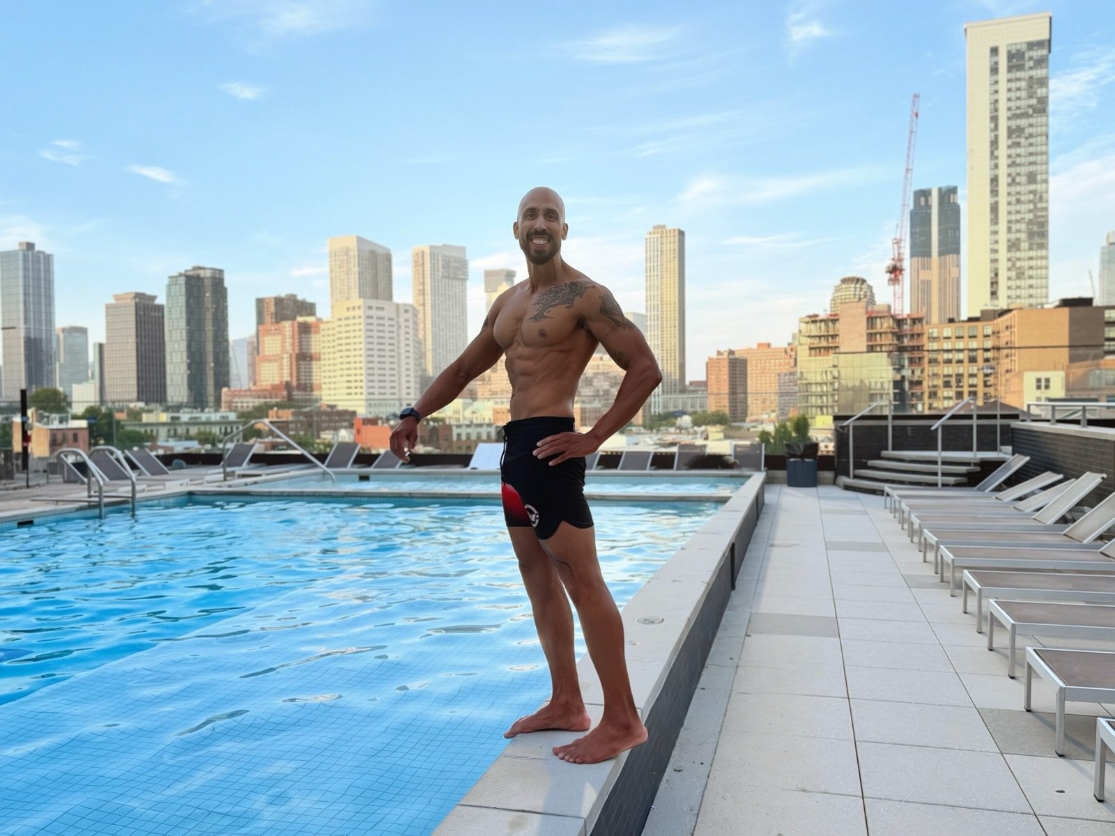 Vinnie Rodriguez, stage-ready physique, NYC skyline behind him