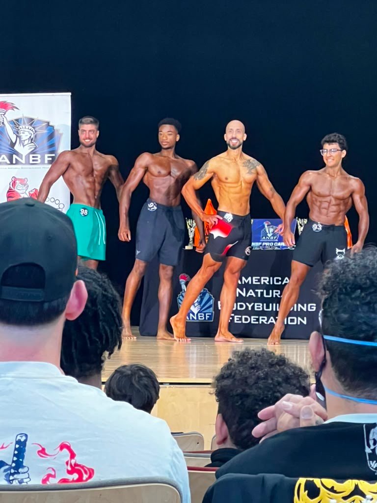 Vinnie Rodriguez posing on stage at the ANBF Men's Physique competition